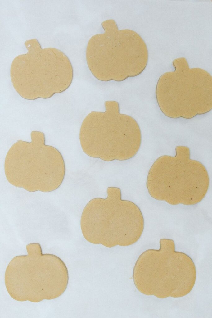 pumpkin shaped cookies on parchment paper