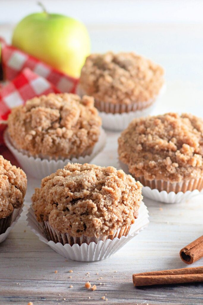 apple muffins on table with  green apple in background 