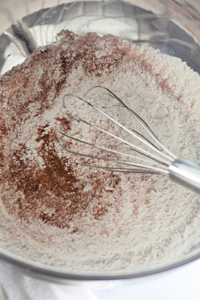 dry ingredients being whisked together in bowl