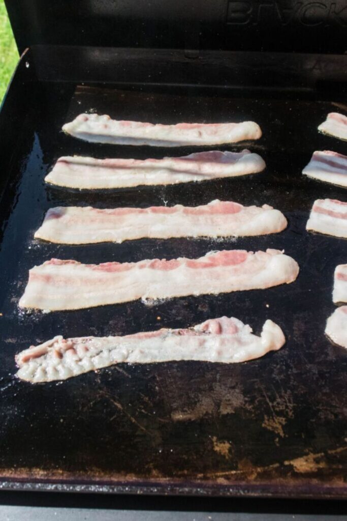 blackstone with bacon cooking 