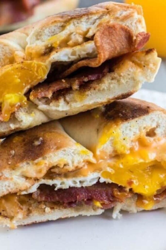Blackstone Bacon Egg and Cheese Sandwich cut in half on a plate 