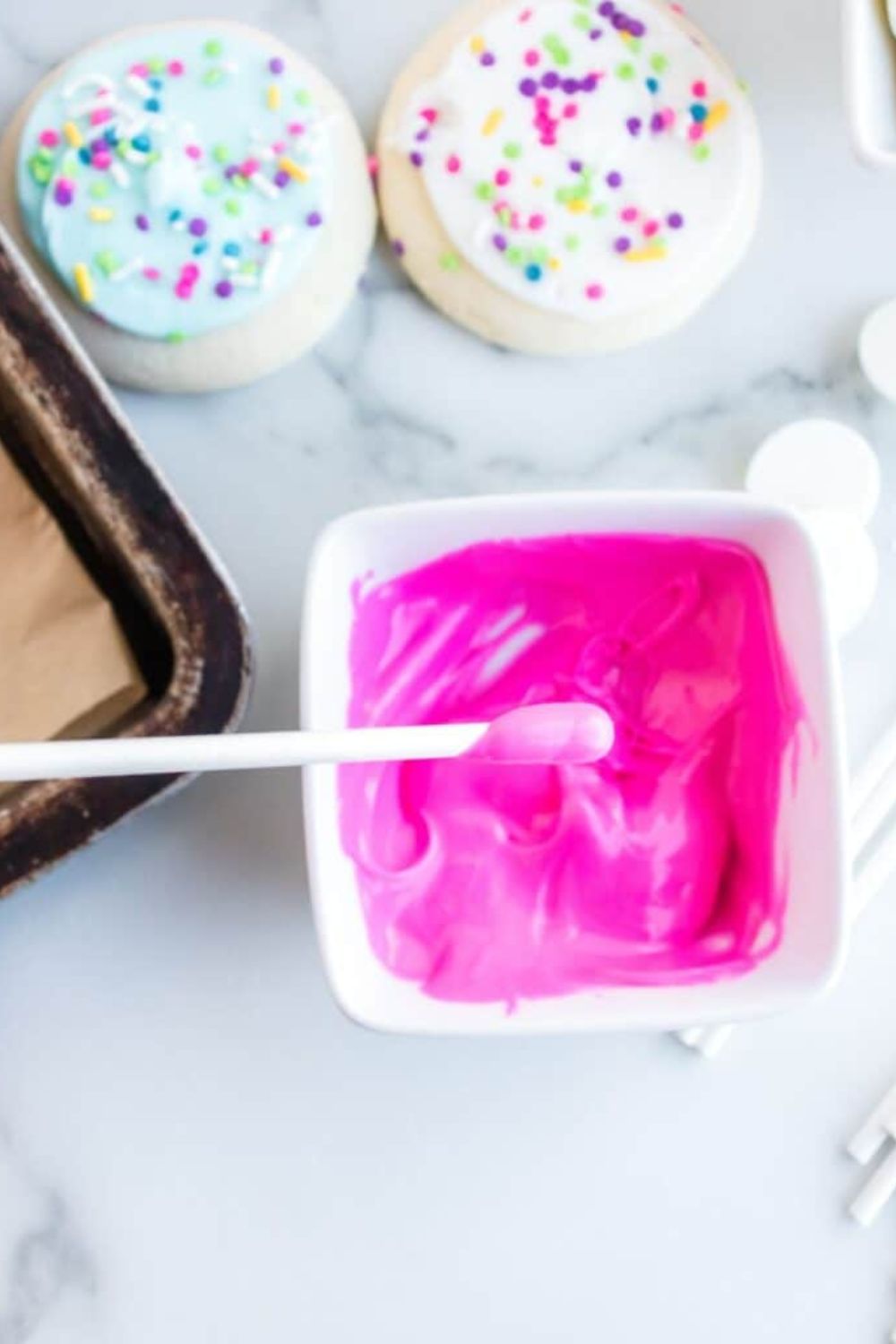 lollipop stick dipped in pink melted candy melts