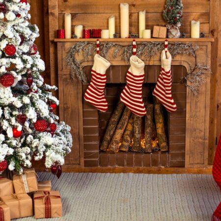 Christmas living room with a Christmas tree and stockings hung by fireplace