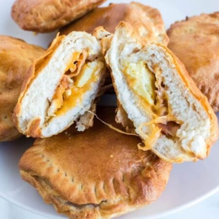 Air Fryer Breakfast Bombs on a plate with one cut in half to show the filling