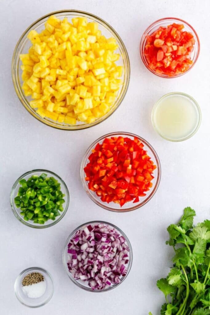 Pineapple Jalapeno Salsa ingredients in bowls on table 