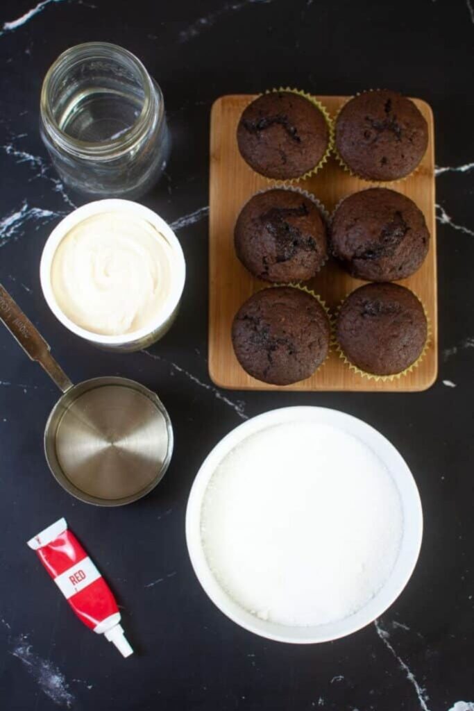 all the ingredients to make the Bloody Cupcakes on a black table