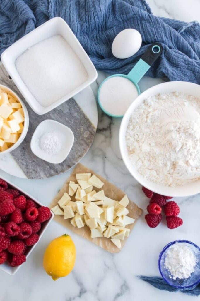all the ingredients for Raspberry Crumble Bars spread out on table in single serve containers
