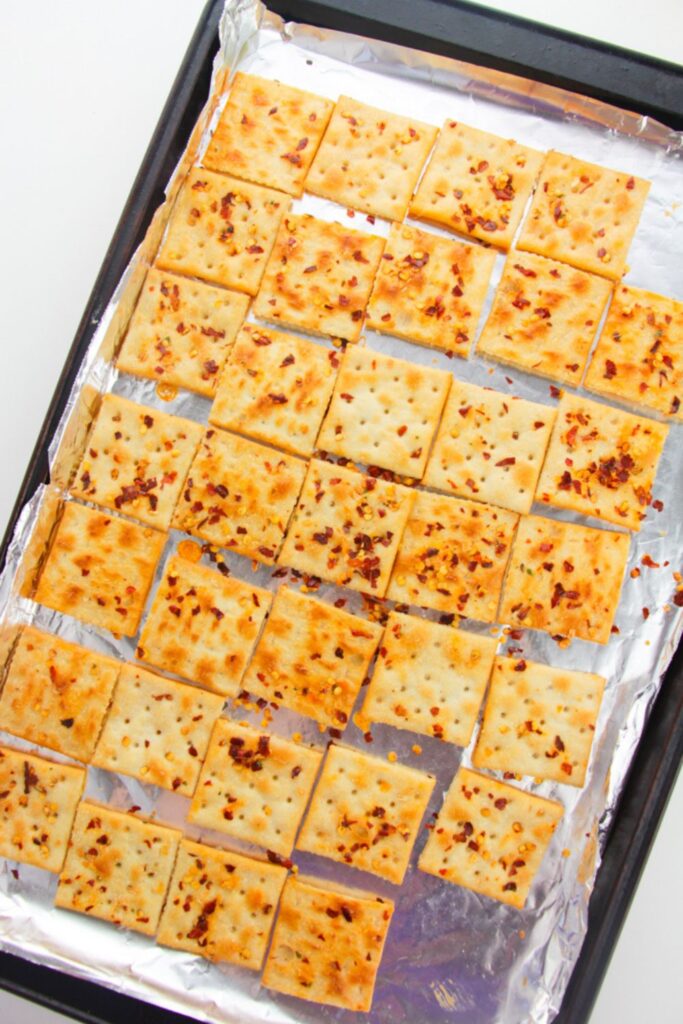 seasoned Alabama heat crackers on a foil lined baking tray on table
