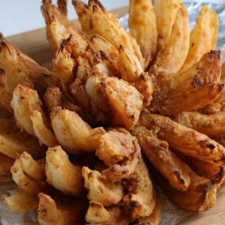 Air Fryer Blooming Onion on a white platter on the table